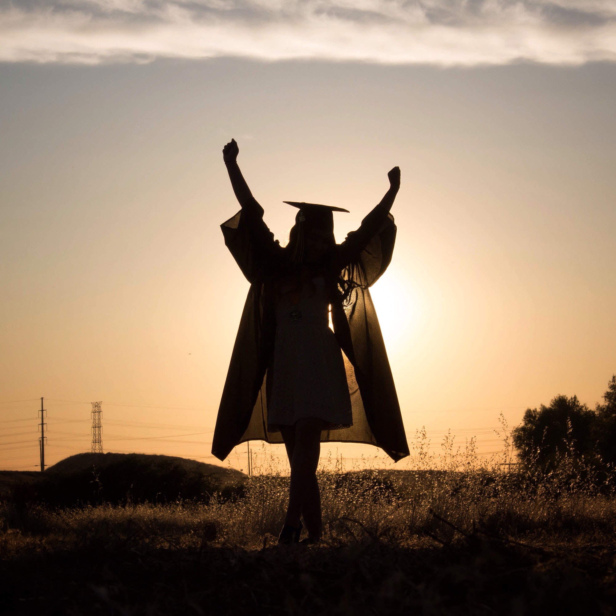 The sky is the limit. Graduate. Complete. Graduation. Hands up. Empowered woman. Finished school.